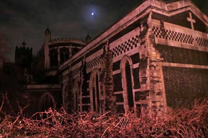 The haunted church of St Bartholomew the Great seen by night.